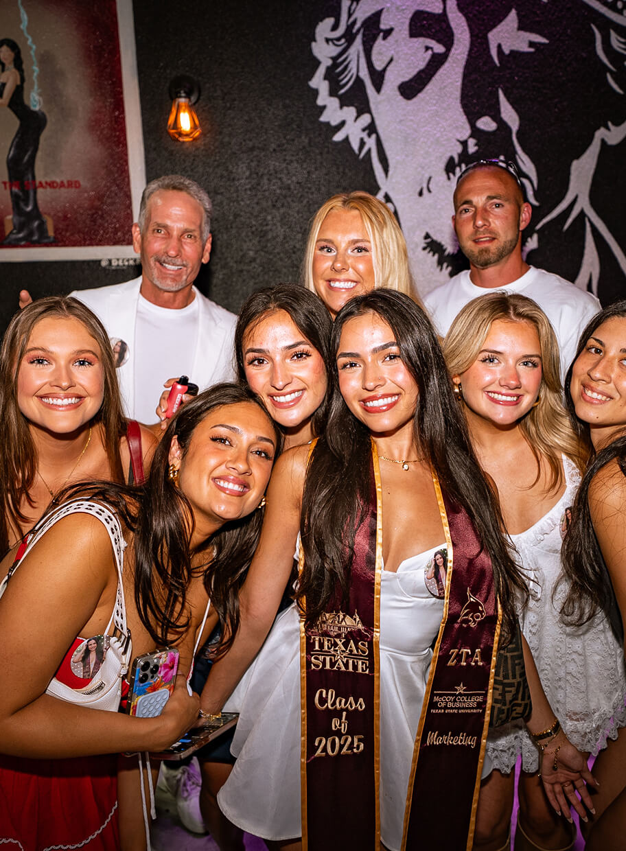 A group of people celebrating a recent college graduation