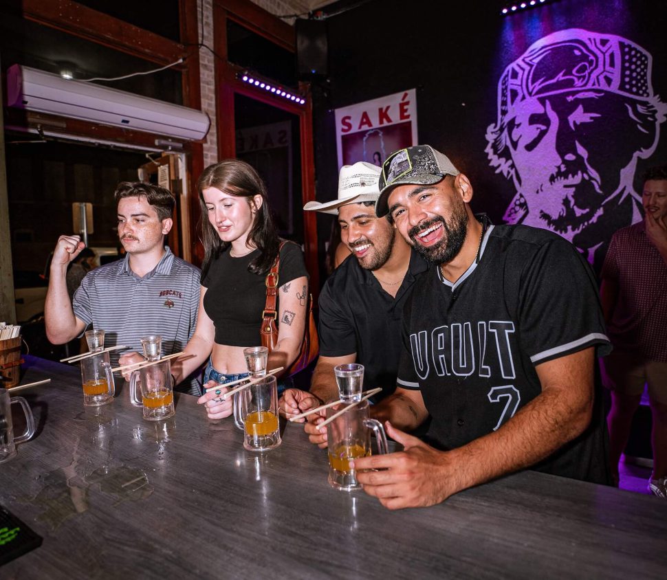 Friends at bar with sake bombs